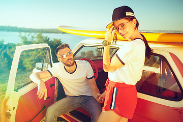 Image showing Couple resting on the beach on a summer day near river