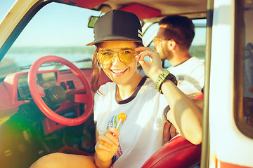 Image showing Laughing romantic couple sitting in car while out on a road trip