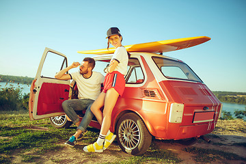 Image showing Couple resting on the beach on a summer day near river