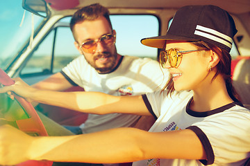 Image showing Laughing romantic couple sitting in car while out on a road trip