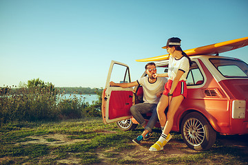 Image showing Couple resting on the beach on a summer day near river