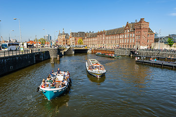 Image showing Sightseeng at Canal Boats near the Central Station of Amsterdam