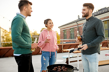 Image showing happy friends having bbq party on rooftop