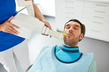 Image showing dentist making dental x-ray of patient teeth