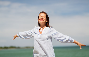 Image showing happy smiling woman on summer beach