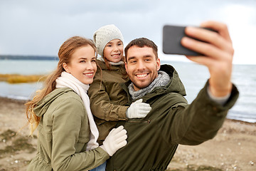 Image showing family taking selfie by smartphone on autumn beach