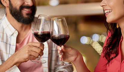 Image showing happy couple drinking red wine at restaurant