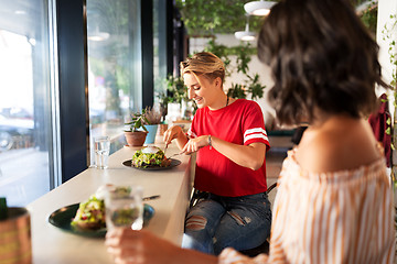 Image showing female friends eating at restaurant