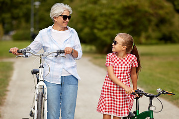 Image showing grandmother and granddaughter with bicycles