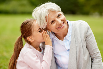 Image showing granddaughter sharing secrets with grandmother