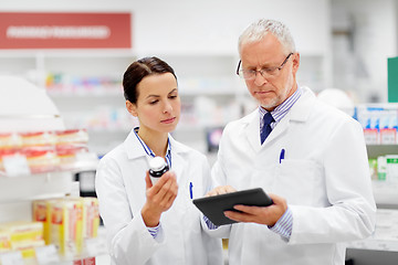 Image showing apothecaries with tablet pc and drug at pharmacy