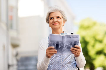 Image showing senior woman or tourist with city guide outdoors