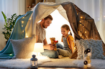 Image showing happy family playing with toy in kids tent at home