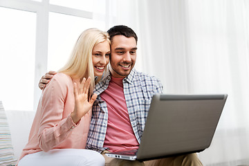 Image showing couple with laptop having video call at home