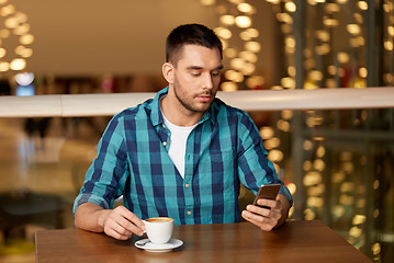 Image showing man with coffee and smartphone at restaurant