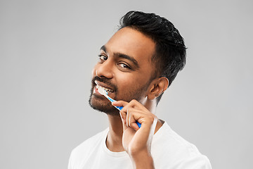 Image showing indian man with toothbrush cleaning teeth