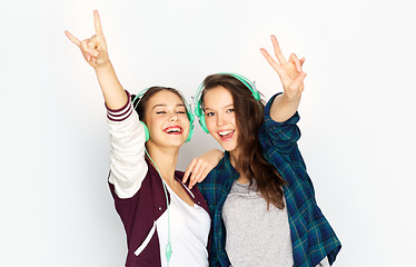 Image showing teenage girls in earphones listening to music