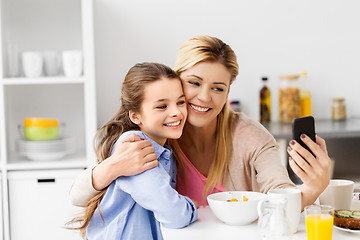 Image showing family taking selfie by smartphone at breakfast