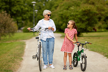 Image showing grandmother and granddaughter with bicycles