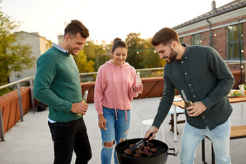 Image showing happy friends having bbq party on rooftop