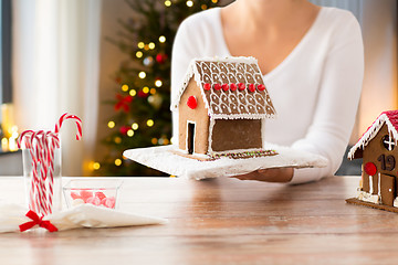 Image showing close up of woman with christmas gingerbread house