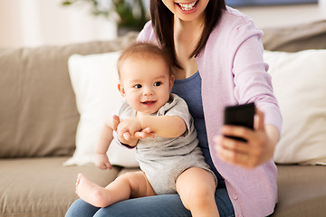 Image showing mother with baby taking selfie at home