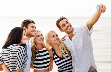 Image showing happy friends taking selfie on summer beach