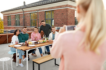 Image showing happy friends photographing at rooftop party