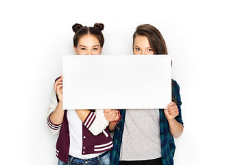 Image showing happy teenage girls holding blank white board