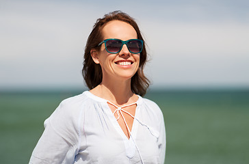 Image showing happy smiling woman in sunglasses on summer beach