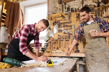 Image showing carpenters with ruler and coffee at workshop