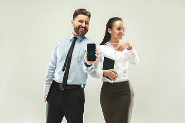 Image showing a business man shows the laptop to his colleague in the office.