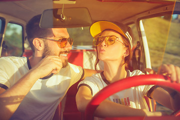 Image showing Laughing romantic couple sitting in car while out on a road trip at summer day