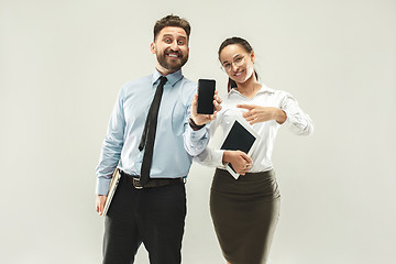 Image showing a business man shows the laptop to his colleague in the office.