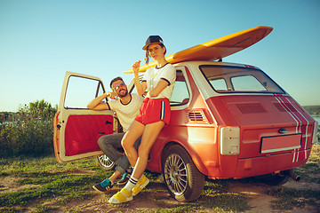 Image showing Couple resting on the beach on a summer day near river