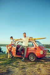 Image showing Couple sitting and resting on the beach on a summer day near river