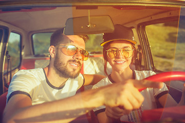 Image showing Laughing romantic couple sitting in car while out on a road trip at summer day