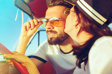 Image showing Laughing romantic couple sitting in car while out on a road trip at summer day