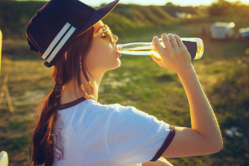 Image showing Woman drinking lemonade at park