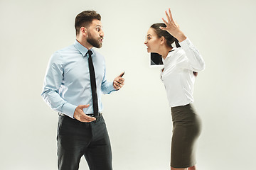 Image showing Angry boss. Man and his secretary standing at office or studio