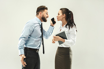 Image showing Angry boss. Man and his secretary standing at office or studio