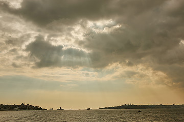 Image showing The rays of the sun breaking through clouds over the sea