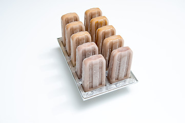 Image showing Plastic molds with coffee homemade ice cream on white background