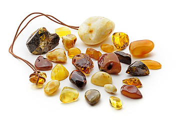 Image showing Natural amber. Many pieces of different colors of natural amber on white background.