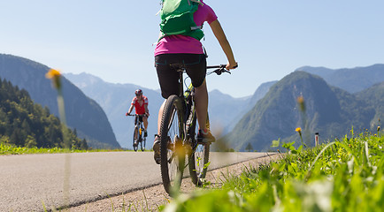 Image showing Active sporty woman riding mountain bike in nature.