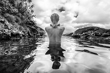 Image showing Naked woman bathing and relaxing in natural swimming pool in black and white.