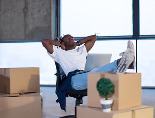 Image showing young black male architect taking a break on construction site