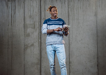 Image showing black business man displaying a spread of american dollar cash m