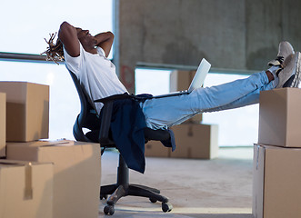 Image showing young black male architect taking a break on construction site