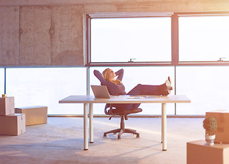 Image showing young female architect taking a break on construction site